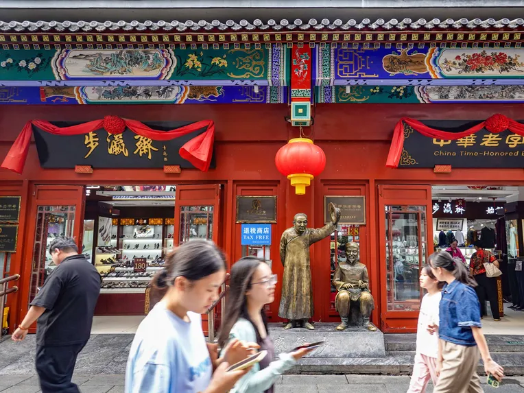 Tourists walk along Qianmen Street in Beijing, China's capital, in August. China's tourism recovery is not much slower than Japan's.